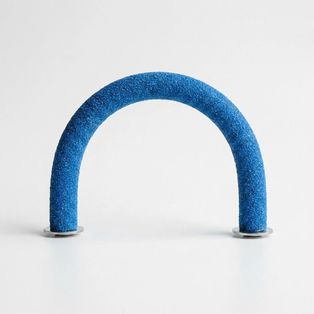 Blue sand-textured arched perch standing upright on its two round metal washers against a plain white background, front view. 1