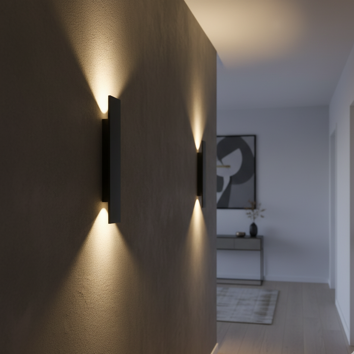 Black wall sconce another view on an indoor hallway wall with warm up and down light.