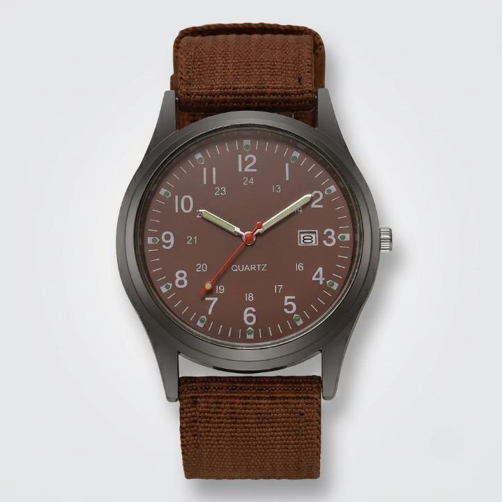 Brown military watch with nylon strap, front view on a light background, showing the brown dial and woven strap.
