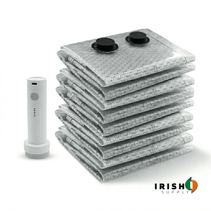 White pump beside folded compression bags with the top bag fitted with two black air valves.