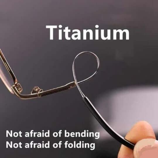 Hand bending a thin temple arm of the glasses into a loop to show its flexible titanium construction.