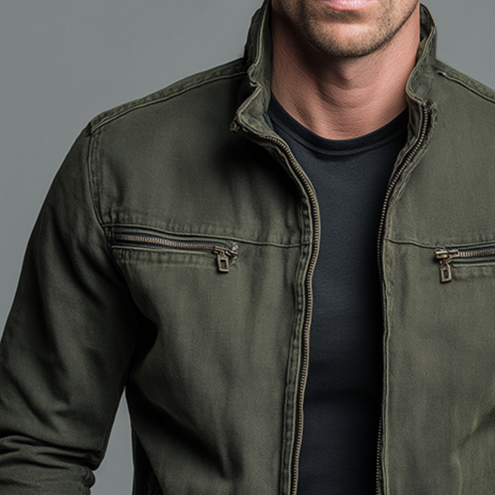 Men's olive green jacket detail showing the stand collar, front zipper and two chest zip pockets.