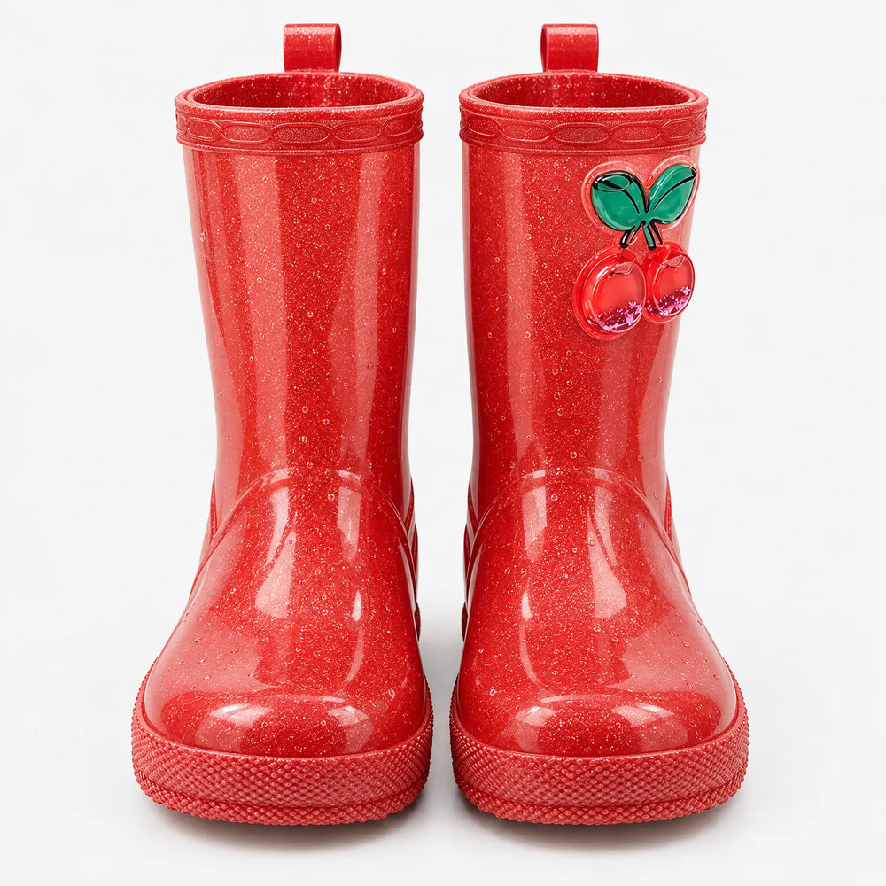 Front view of a pair of red glitter rain boots with pull loops and a cherry charm on one boot. 2