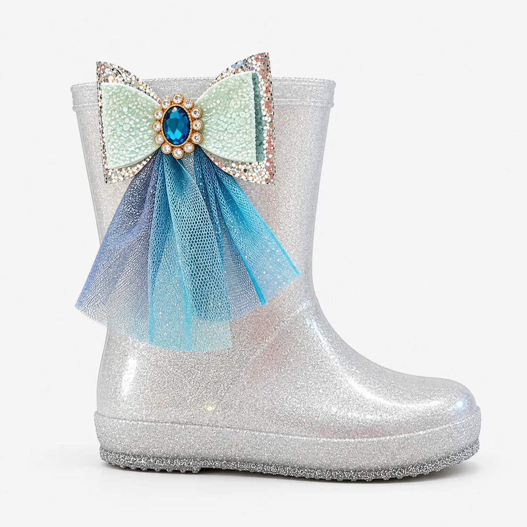 Side view of a single silver glitter rain boot with a mint glitter bow, blue gem and layered blue tulle. 4