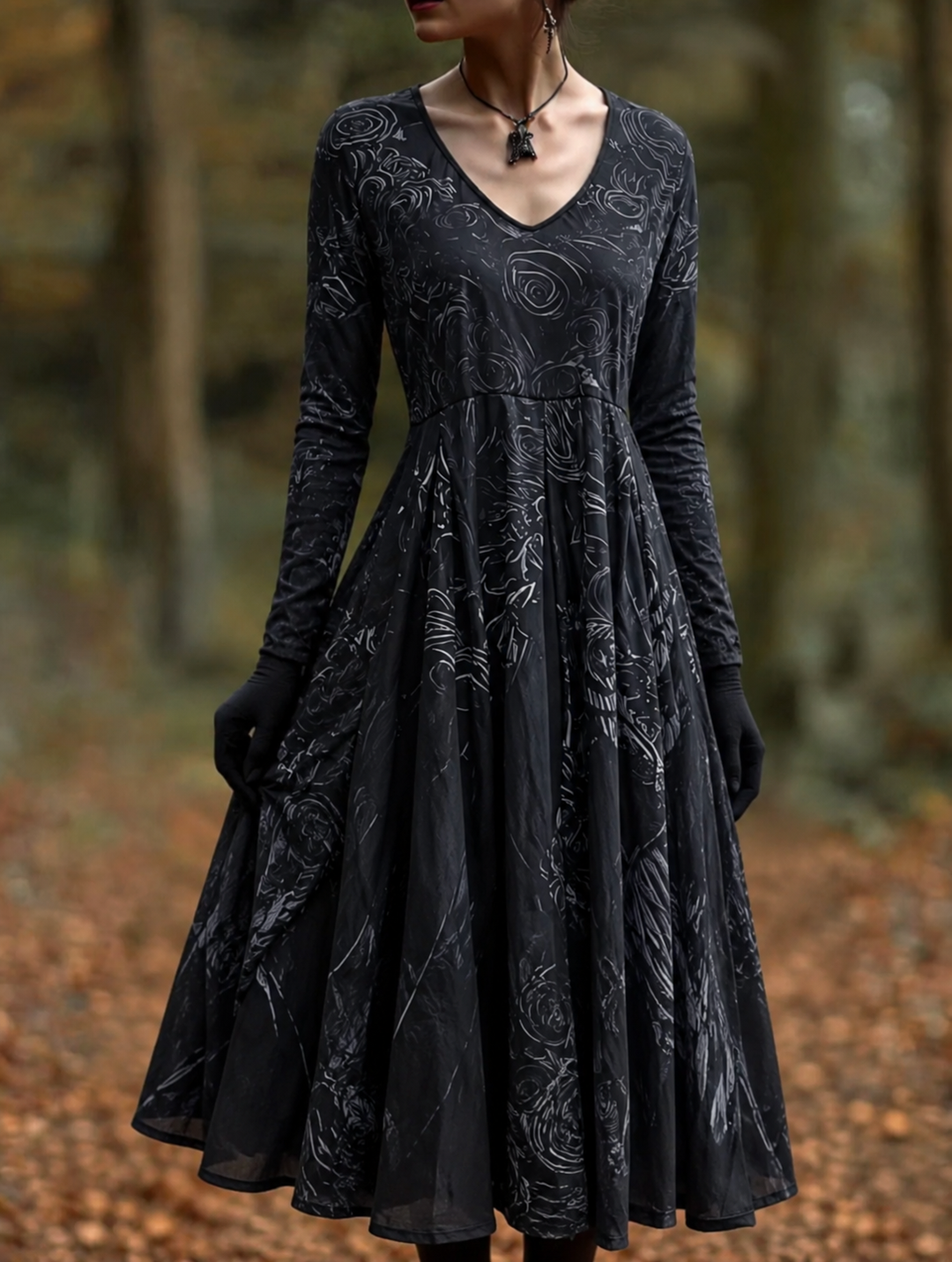 Black long-sleeved V-neck dress with a full flared skirt and rose-like pattern