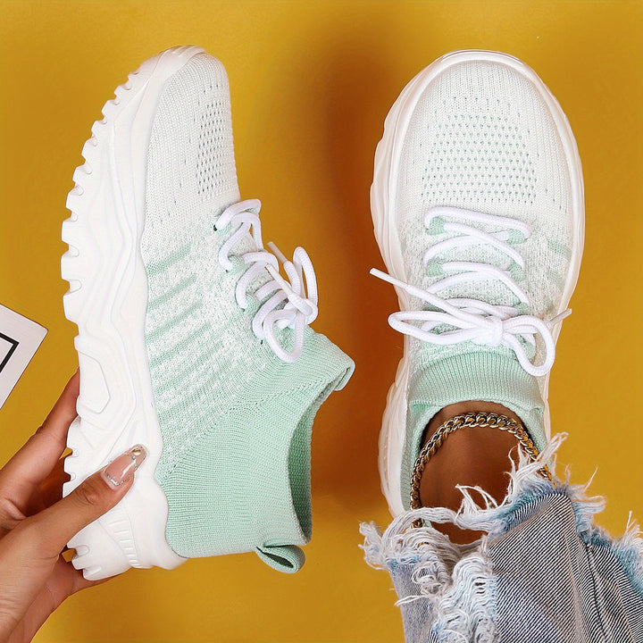 White and pale mint knit sneakers with white laces and white chunky soles, top-down view.
