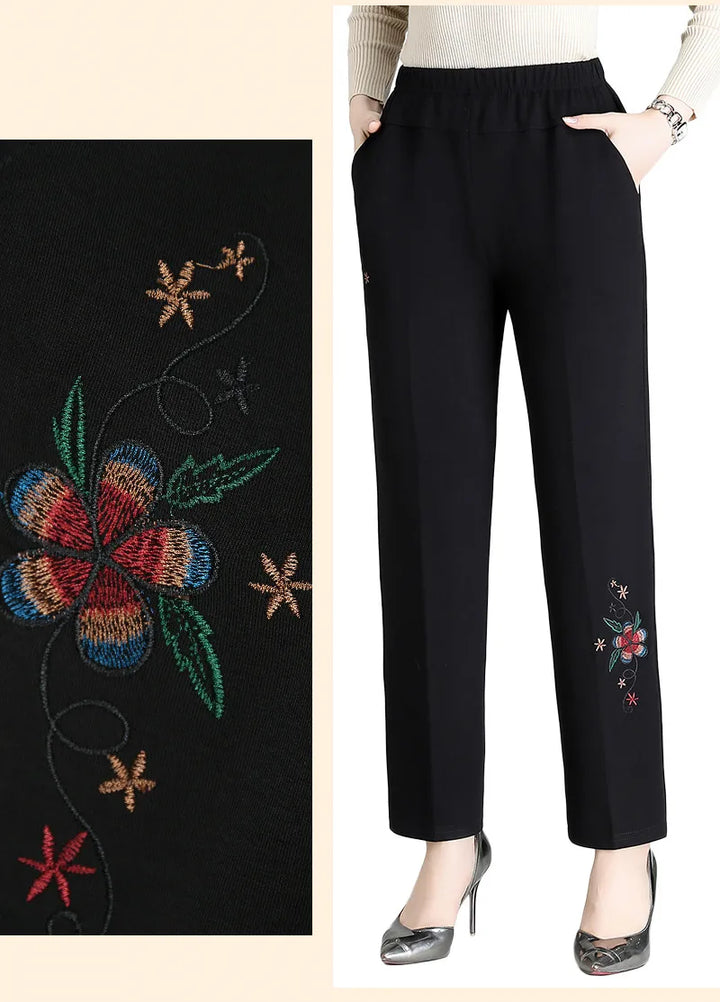 Schwarze Damenhose mit bunter Blumenstickerei, elastischer Bund, elegant, modisch.
