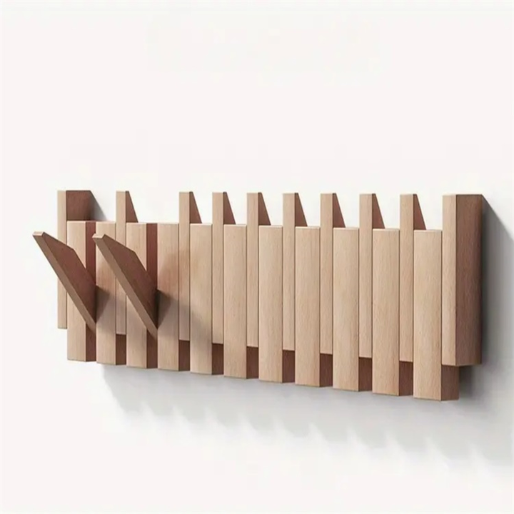Light wood rack mounted on a white wall, two hooks folded out while the rest sit flat in a staggered row. 1
