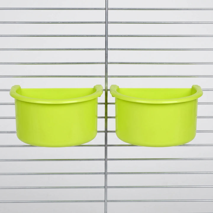 Two green half-round bowls hanging side by side on the bars of a metal cage, shown from the front. 4