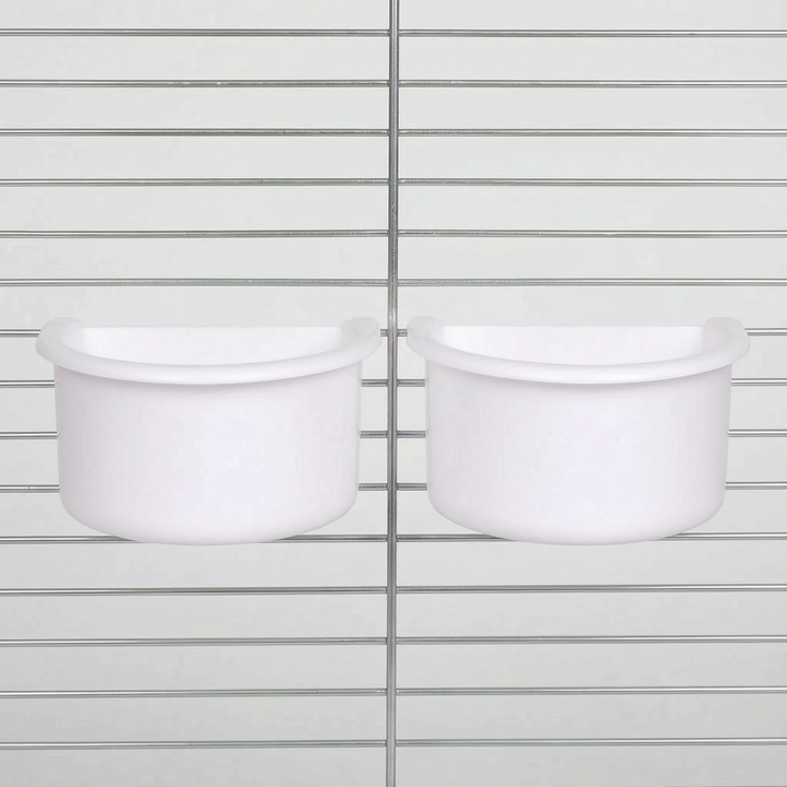 Two white half-round bowls hanging side by side on the bars of a metal cage, shown from the front. 5
