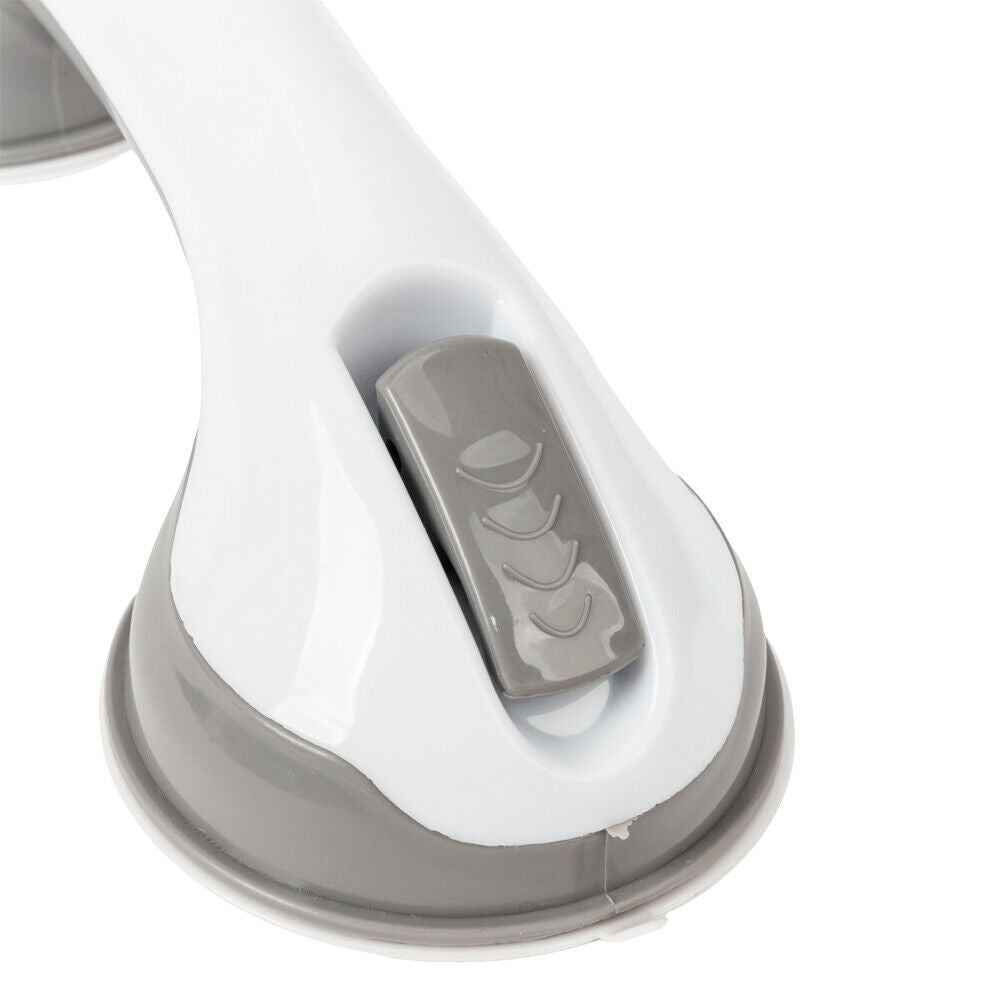Close-up of the gray release tab and suction cup base on the white and gray grab bar.