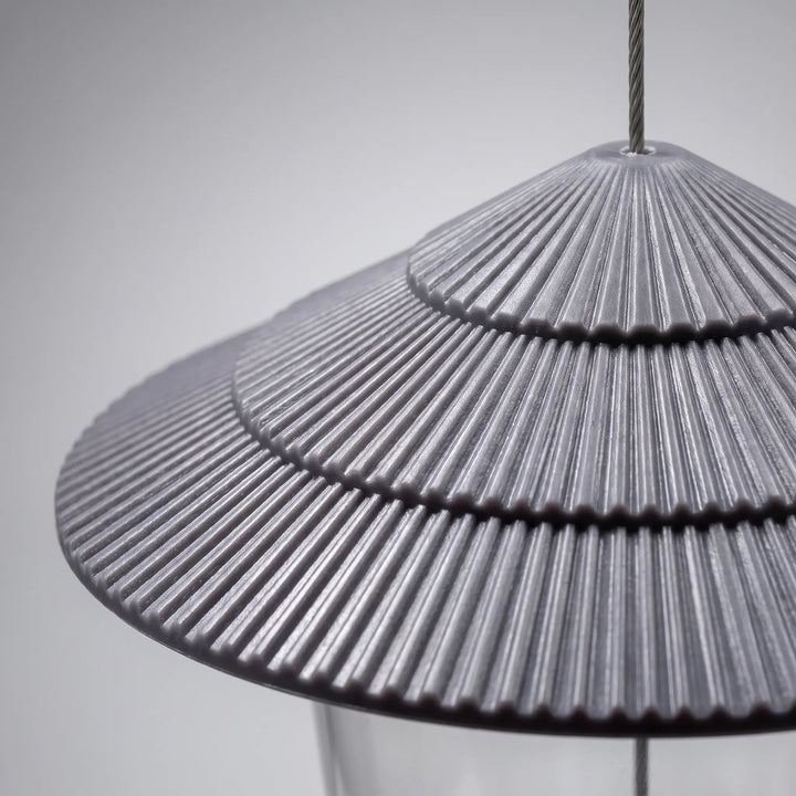 Close-up of the gray tiered roof showing its fine radial ribbing, with the hanging wire rising from the top. 3