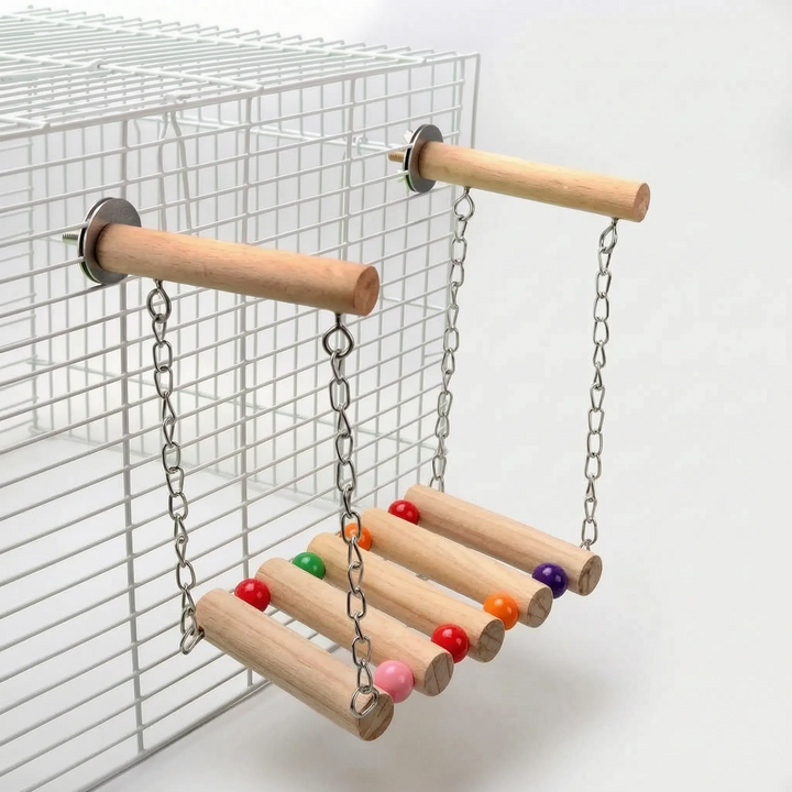 Swing version with colorful beads at the log ends, hung by chains from two wooden perches bolted to a white wire cage. 4