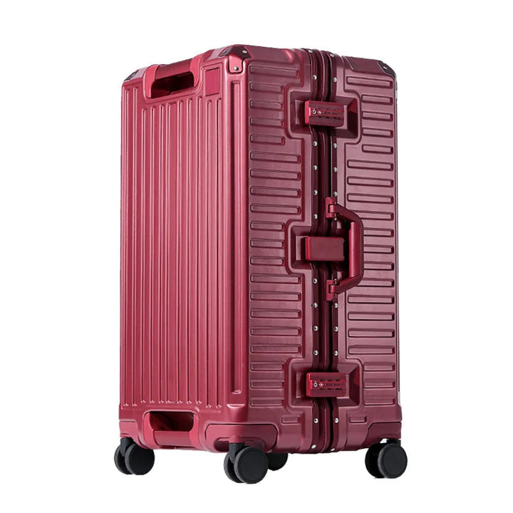 Red ribbed hardshell suitcase with riveted aluminum frame, side handle, two combination locks and four black spinner wheels.