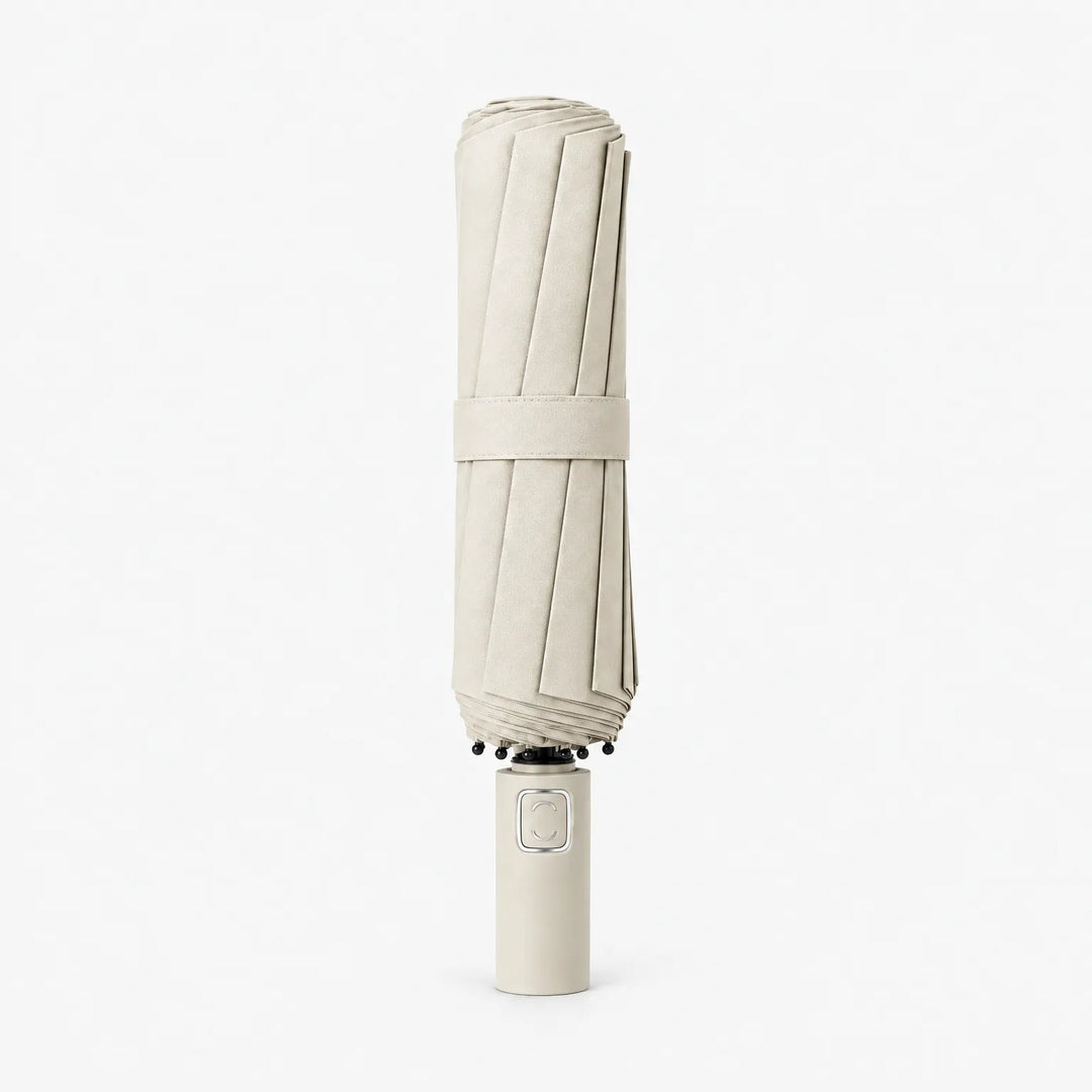 Folded cream umbrella with matching strap standing upright on its handle against a white background. 10