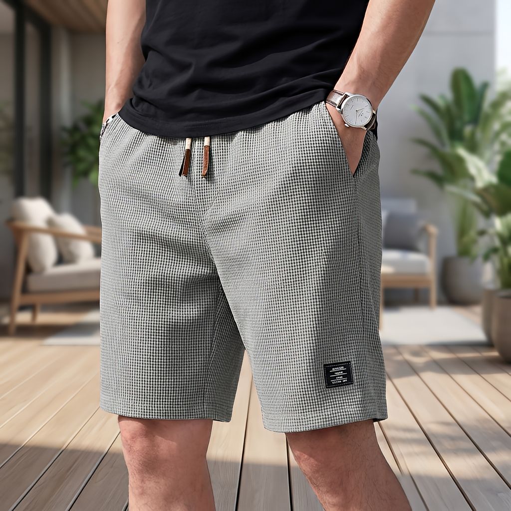 Men's light gray waffle-textured shorts with drawstring waist and small patch at the hem, another view.