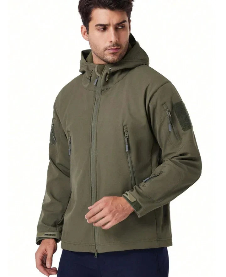 Model wearing the olive green hooded jacket, front view with zip pockets and sleeve patch 5