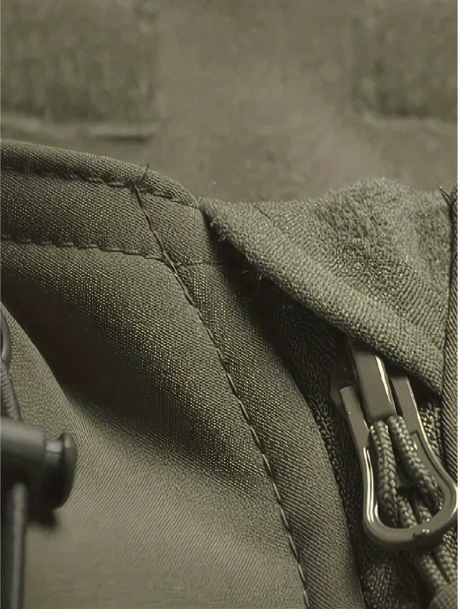 Close-up of the olive jacket's collar, seam stitching and zipper pull with cord 8