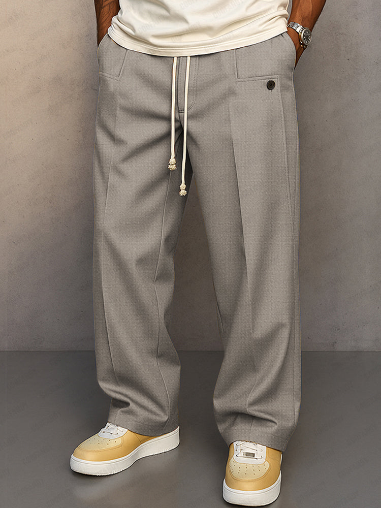 Men's grey relaxed fit pants, front view.