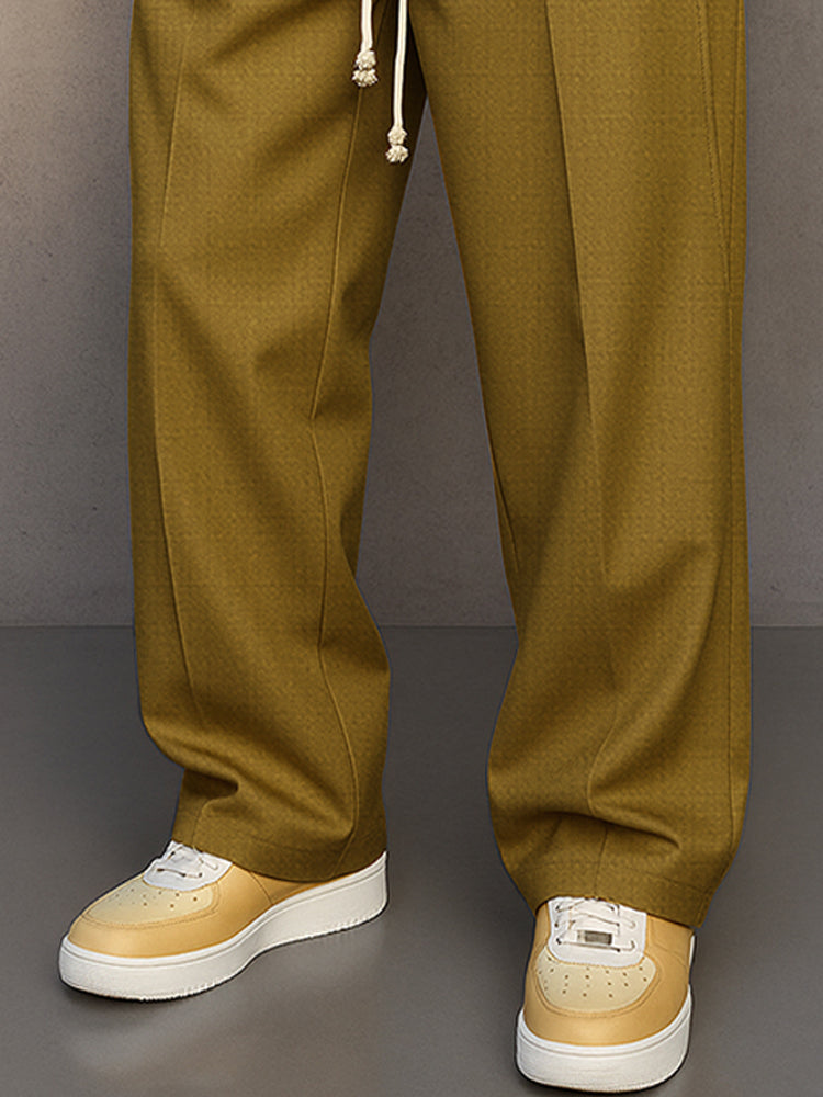 Men's grey relaxed fit pants, detail of the lower legs.
