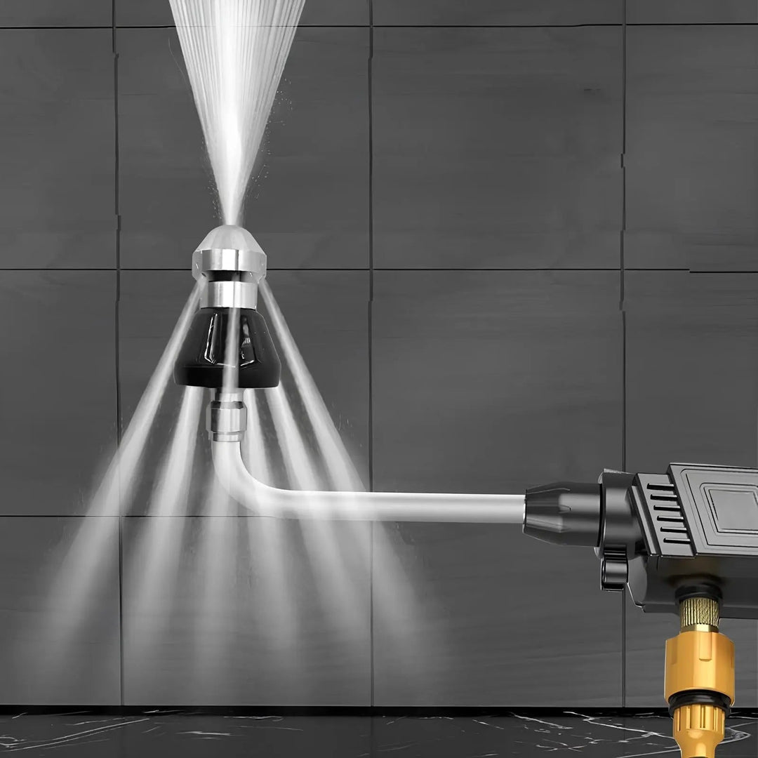 Another view of the nozzle on a bent lance attached to a handheld pressure washer spraying against a dark tile wall.