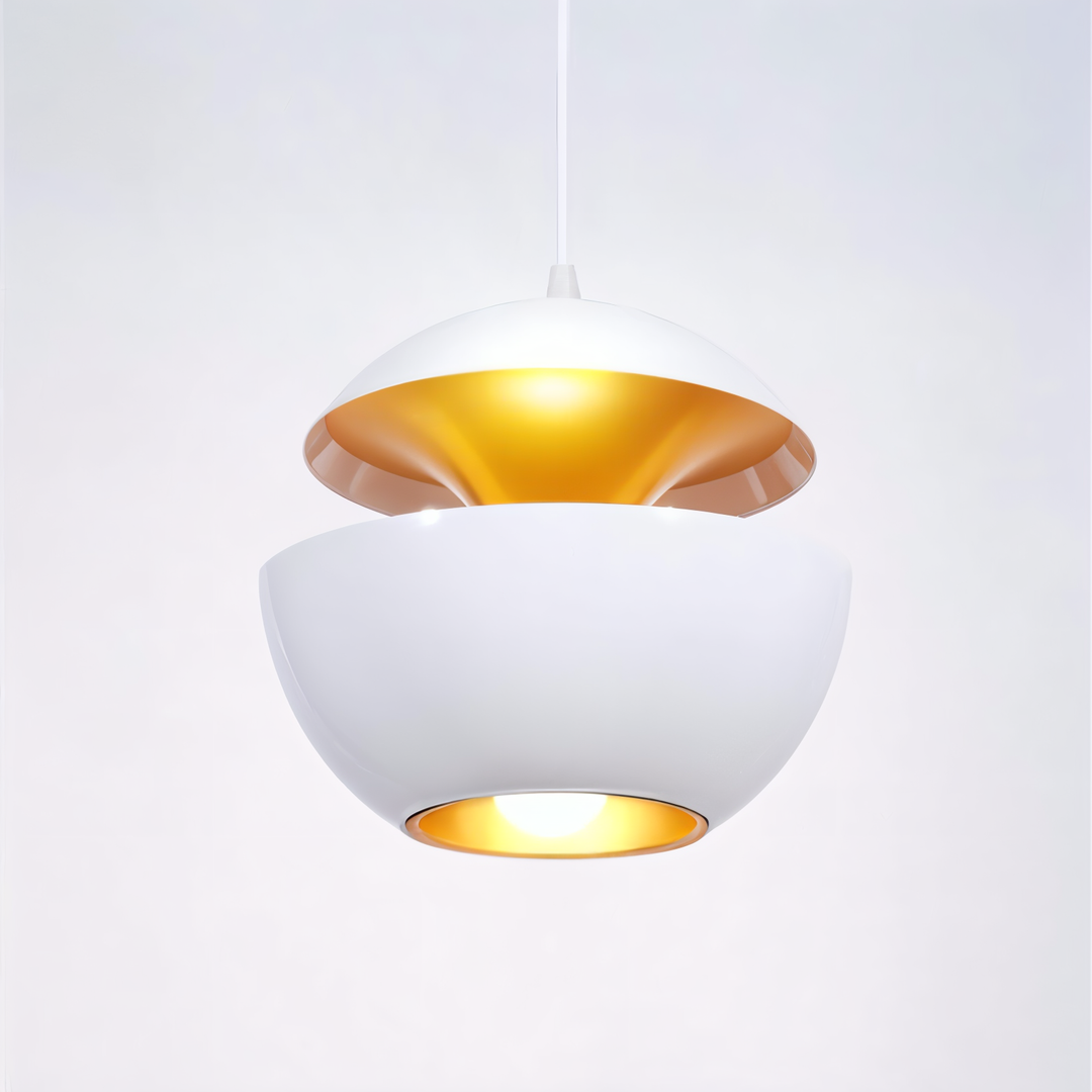 White version of the split apple-shaped pendant lamp with a gold-toned interior, hanging from a white cord with the bulb lit. 22
