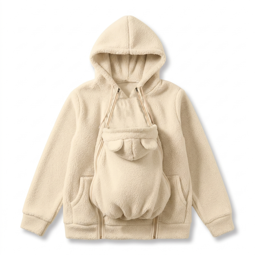 Cream fleece hoodie showing the bear-eared baby pouch panel, side pockets and double zippers.