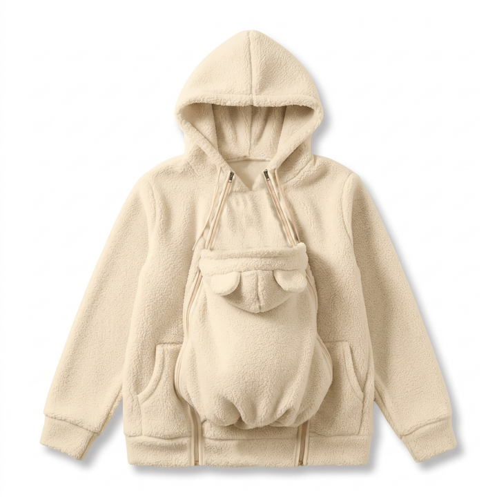 Cream fleece hoodie showing the bear-eared baby pouch panel, side pockets and double zippers.