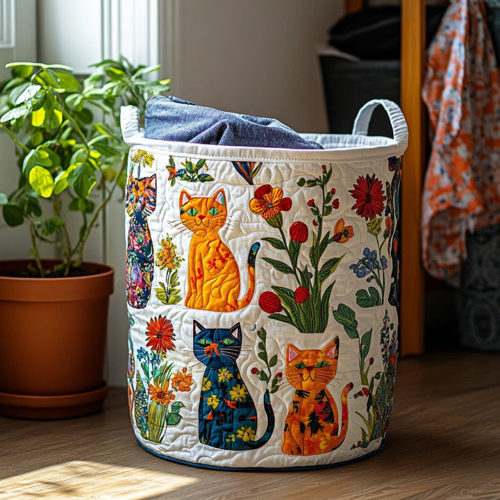 Round quilted hamper with colorful appliqued cats and flowers on white, filled with blue fabric beside a potted plant. 1