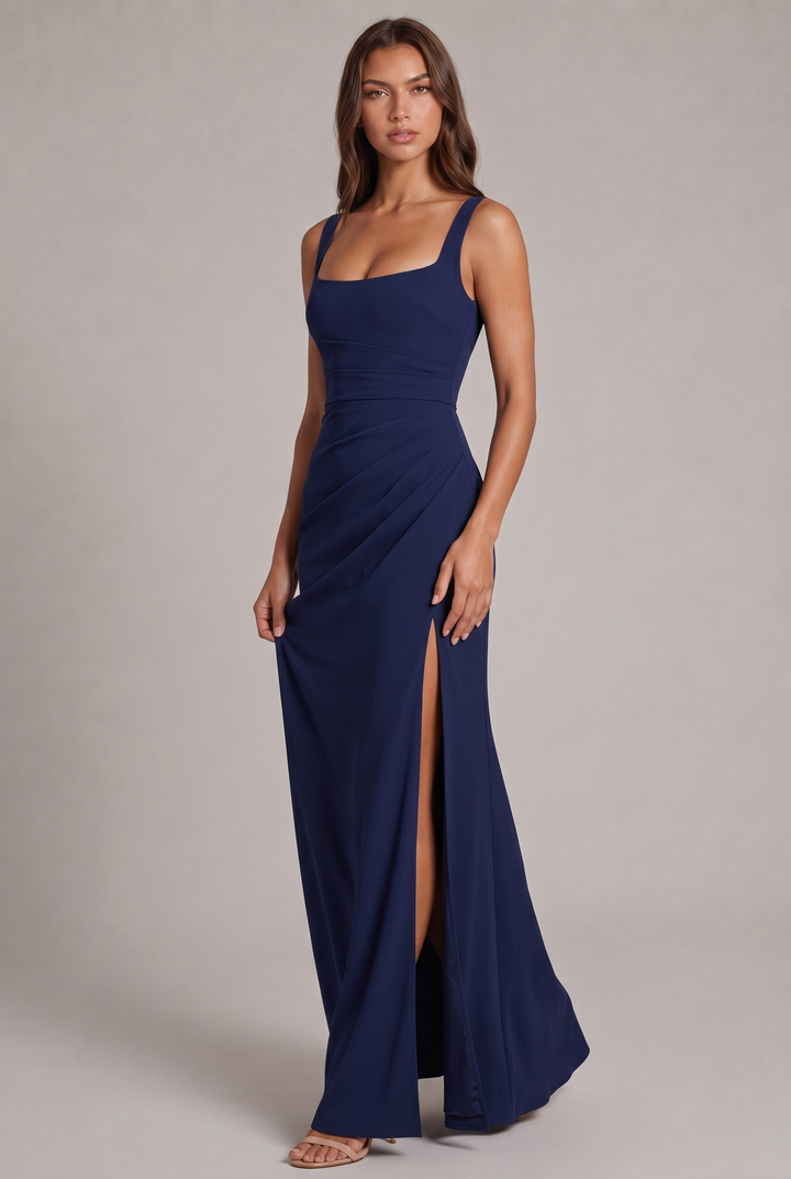 Model in a navy square-neck maxi dress with ruched waist and high side slit, full-length front view with nude heels. 1