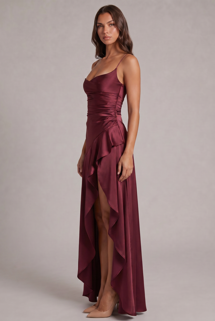 Side view of the burgundy satin dress showing side-ruched waist, cascading ruffle and high front slit 3