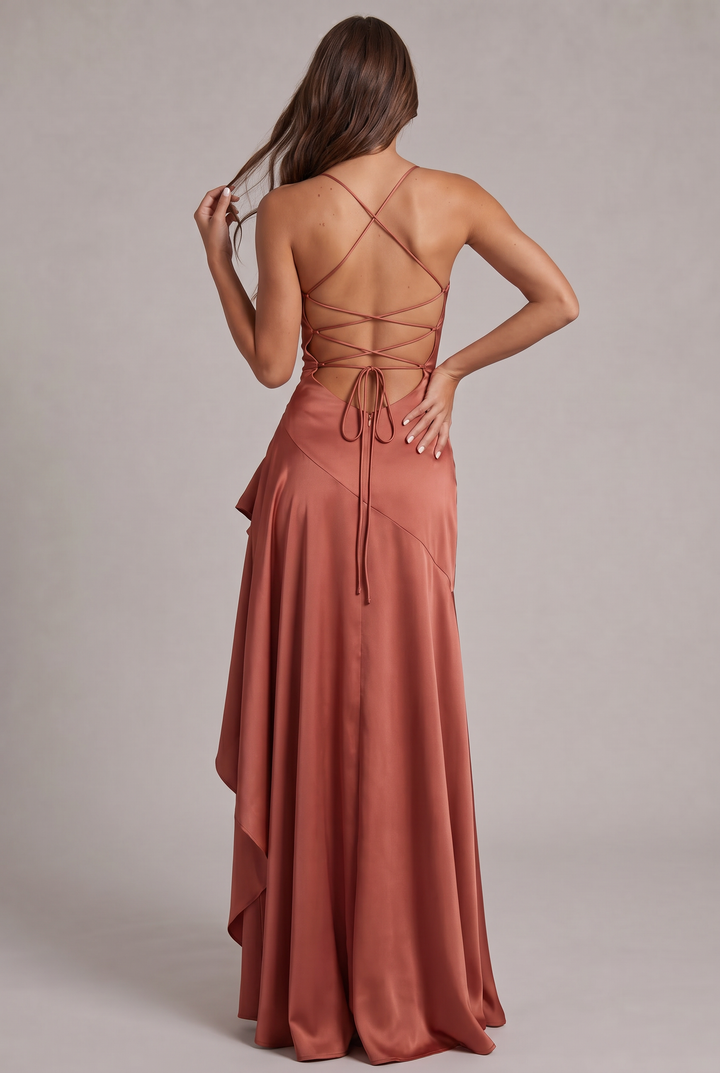 Back view of terracotta satin dress with lace-up crisscross straps and hair held in one hand 27