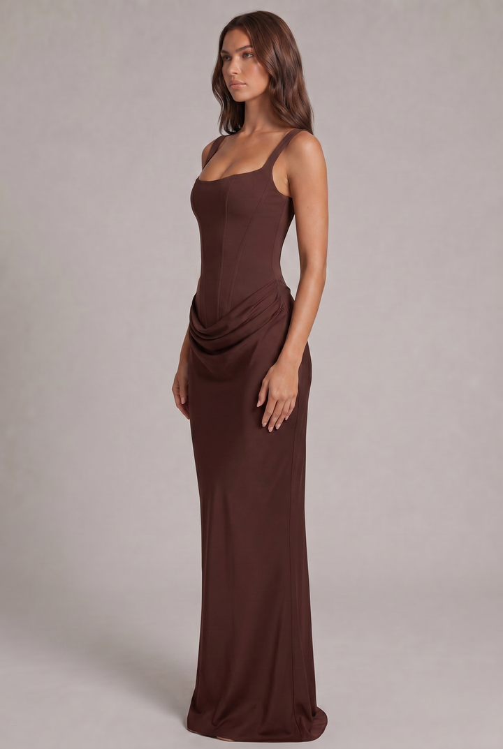 Another view of the black maxi dress showing the draped hip detail and slim column skirt.