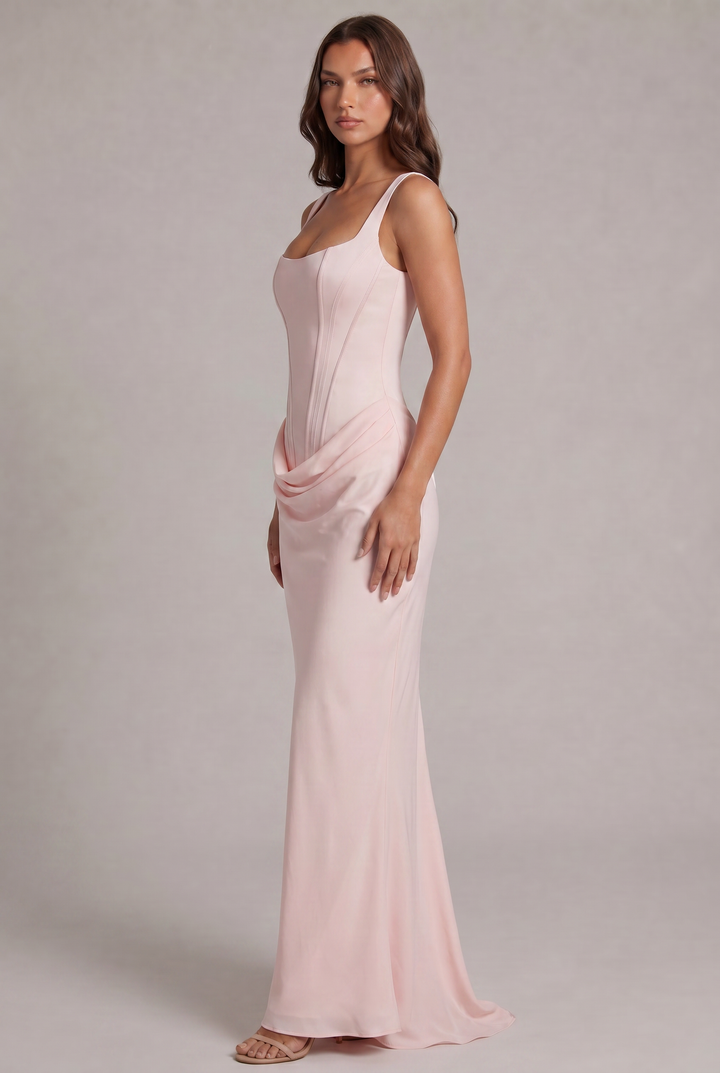 Side view of the light pink gown on a model, showing the fitted corset bodice, soft draping at the hip and flowing skirt with a train. 27
