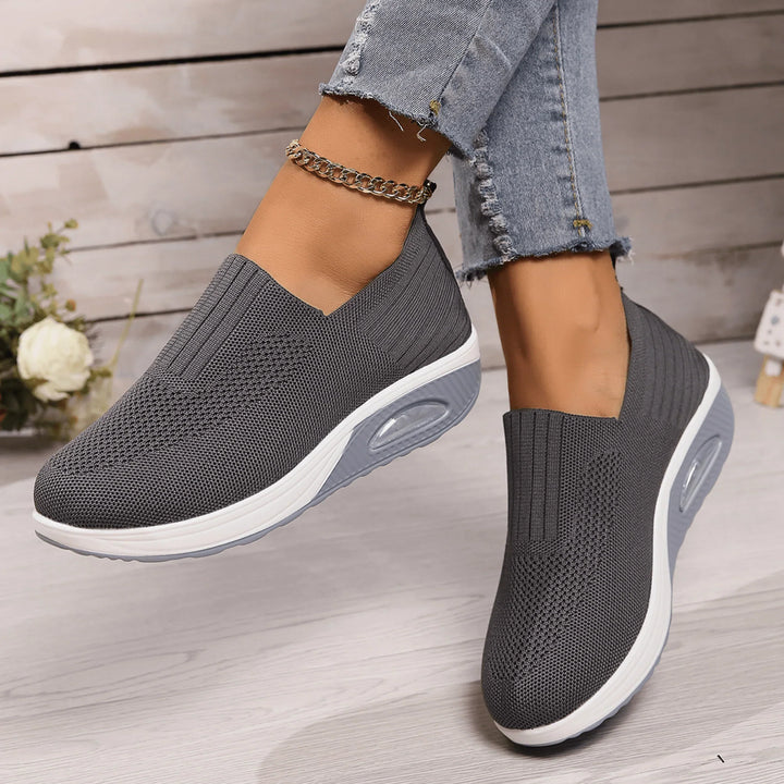 Dark gray knit slip-on sneakers with white and light gray soles, another view