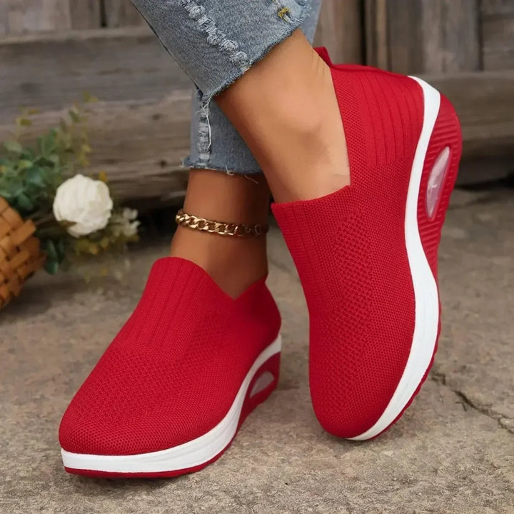 Bright red knit slip-on sneakers with white platform soles and air cushion detail