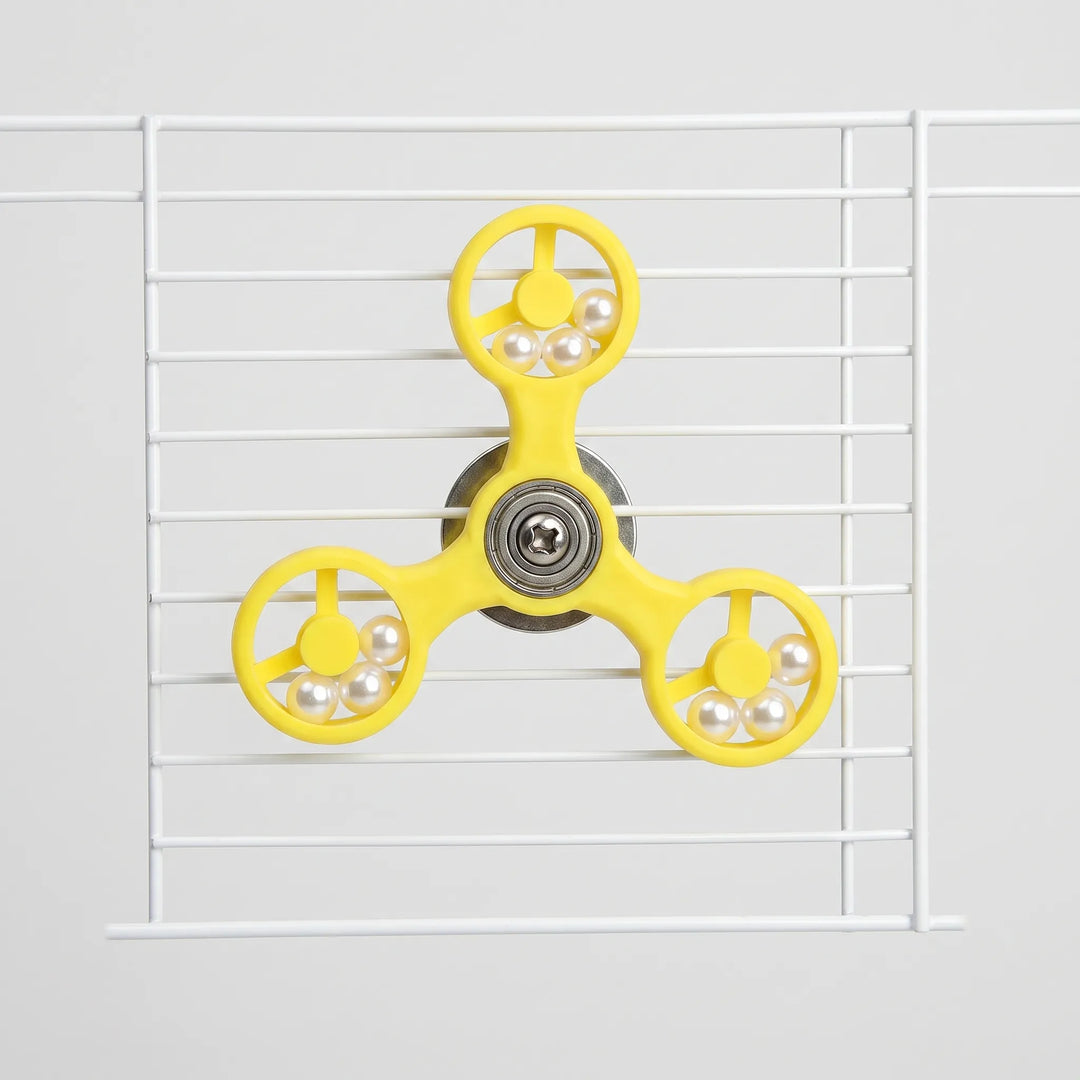 Front view of the yellow three-armed spinner with pearl beads in each ring, mounted on white cage wires. 1