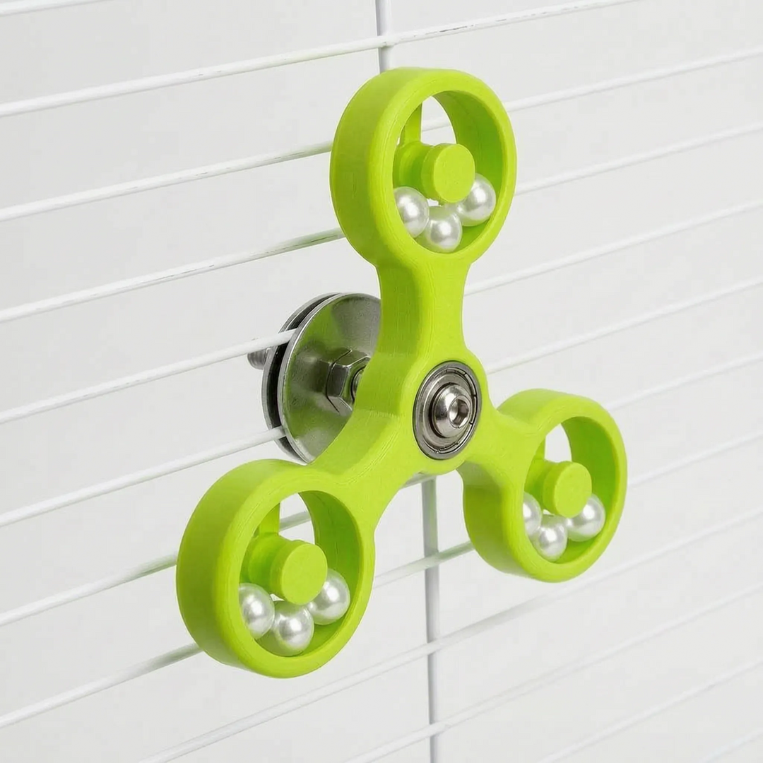 Lime green version of the spinner mounted on white cage bars, showing the steel washer and nut behind the center bearing. 6