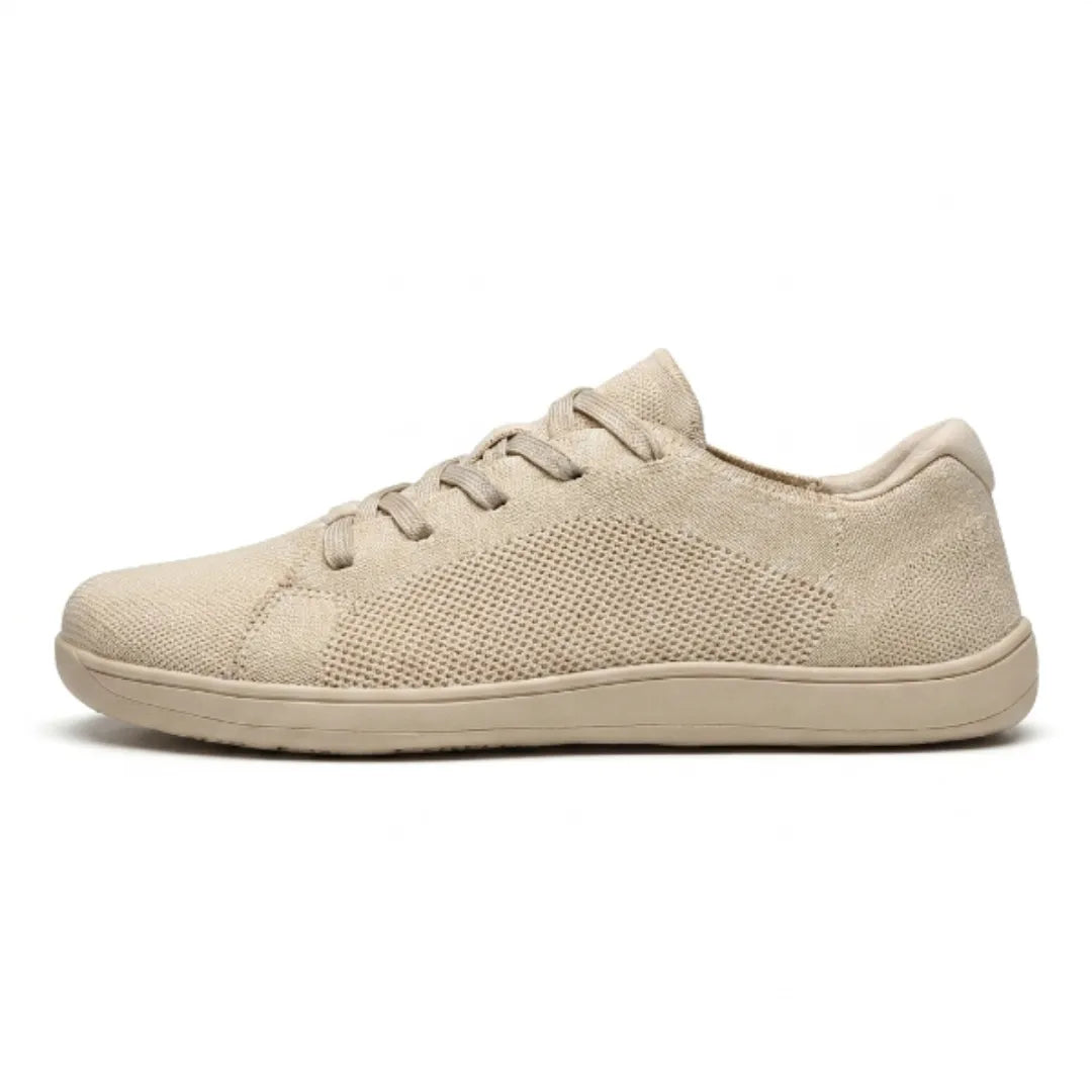 Beige knit lace-up sneaker with a perforated mesh panel and a flat, flexible sole.