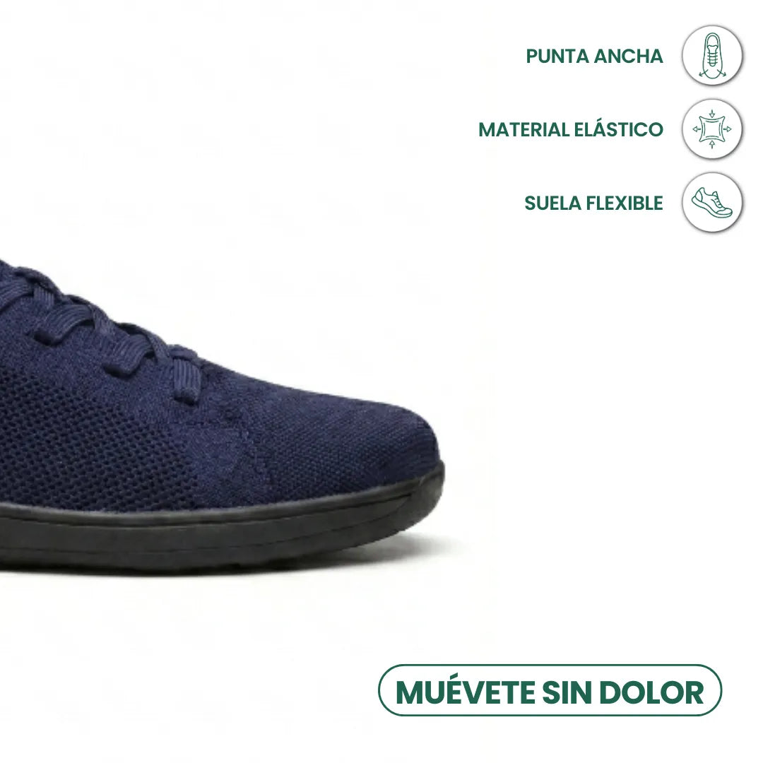 Close-up of the wide toe area of a navy knit sneaker with a black sole, with icons about flexibility and toe room. 23