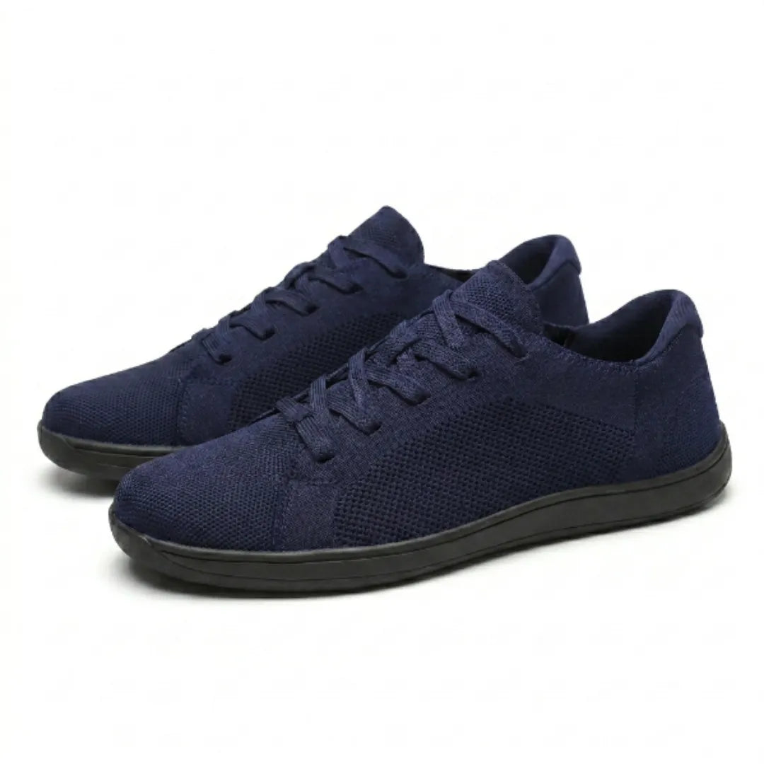 Pair of navy blue knit sneakers with black soles and matching laces, shown at an angle on a white background. 25