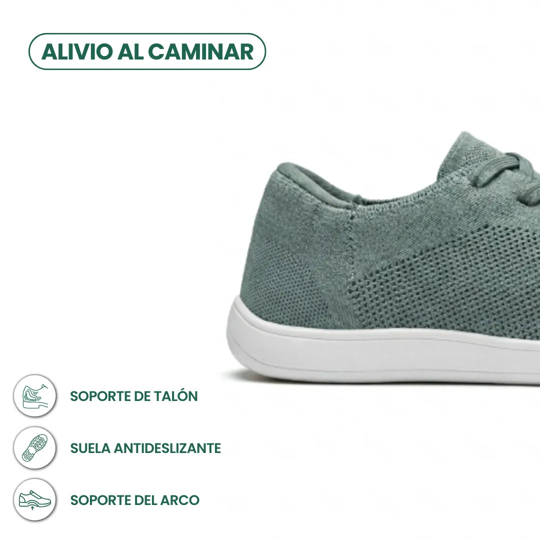 Close-up of the heel of a sage green knit sneaker with white sole, with icons about heel support, grip and arch support. 31