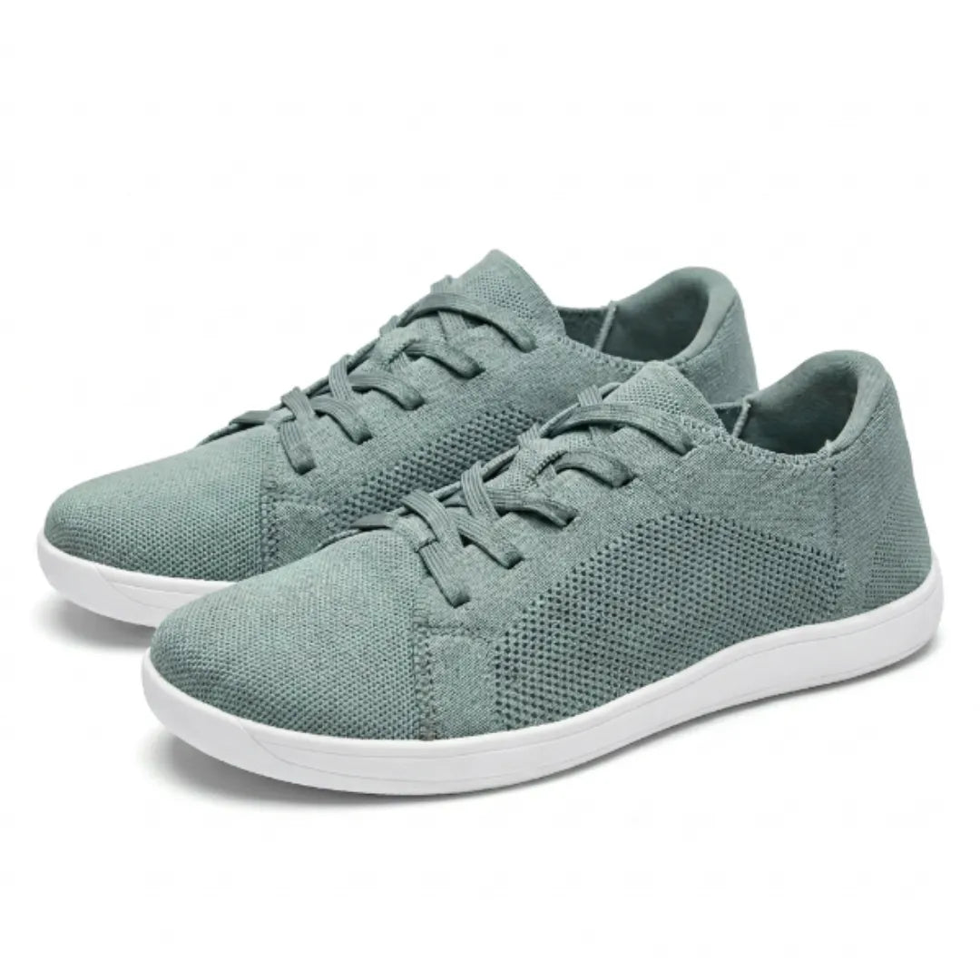 Pair of sage green knit sneakers with white soles and matching laces, shown at an angle on a white background. 34