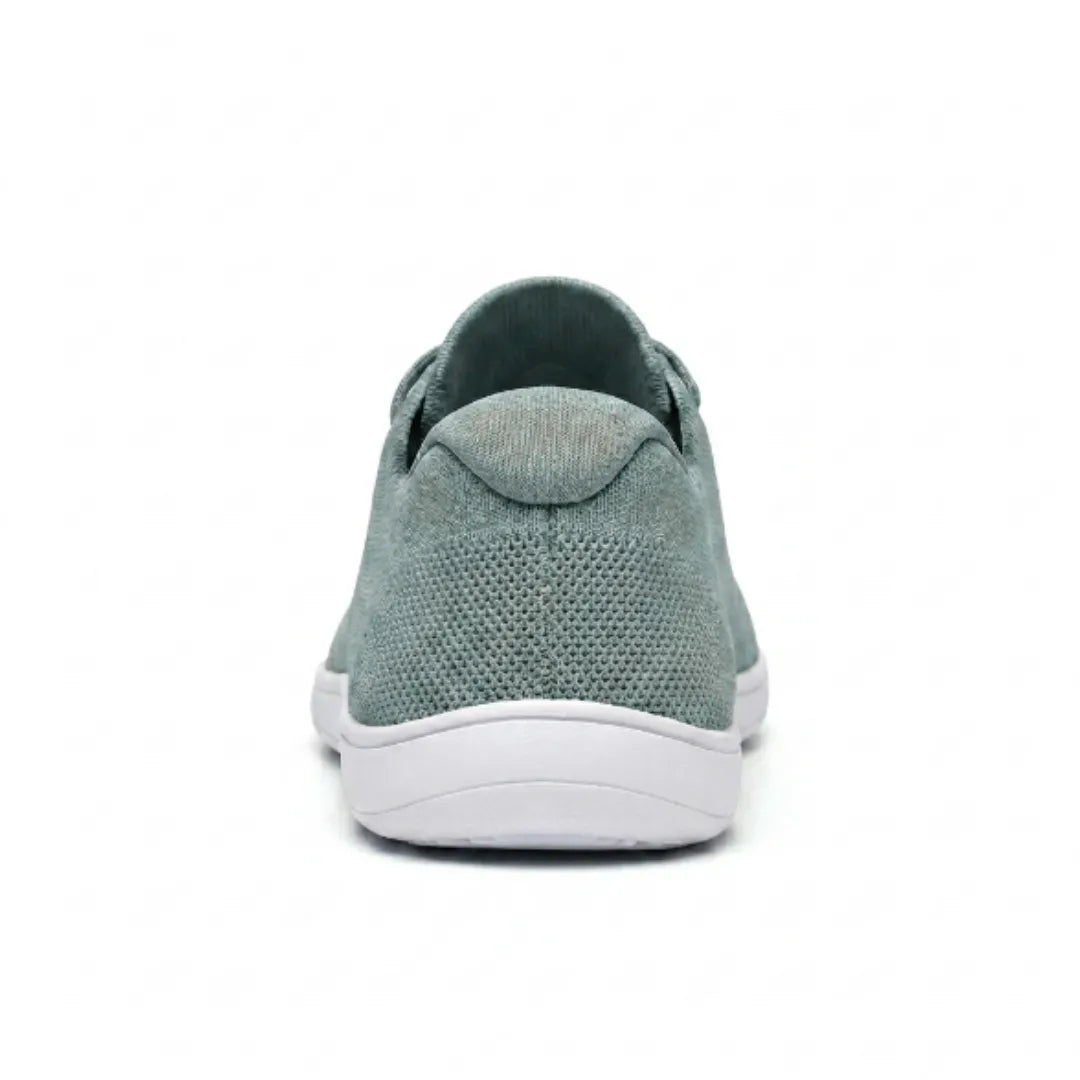 Rear view of a sage green knit sneaker with white sole, showing the heel tab and textured mesh back. 36