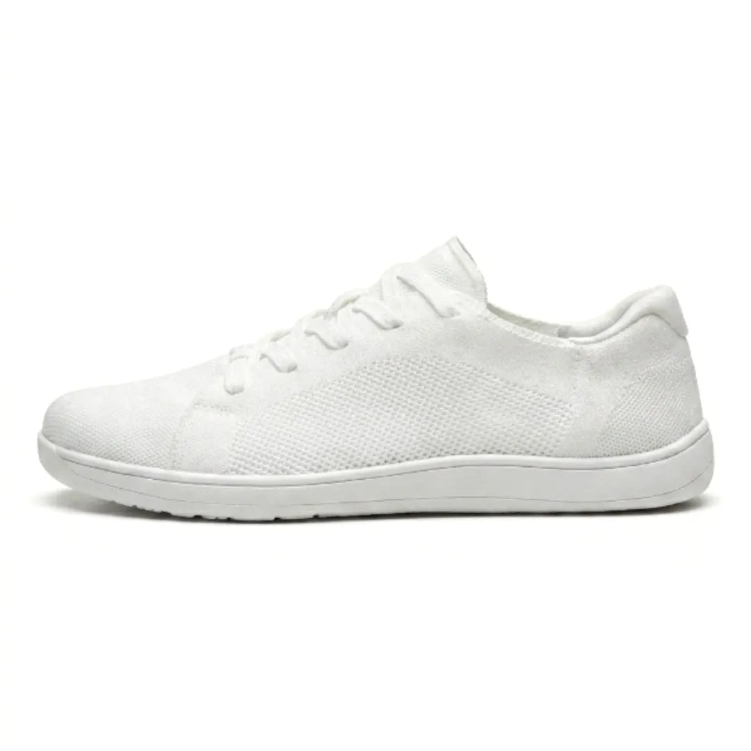 Side view of a single all-white knit sneaker with white sole, mesh panel and white laces on a white background. 37