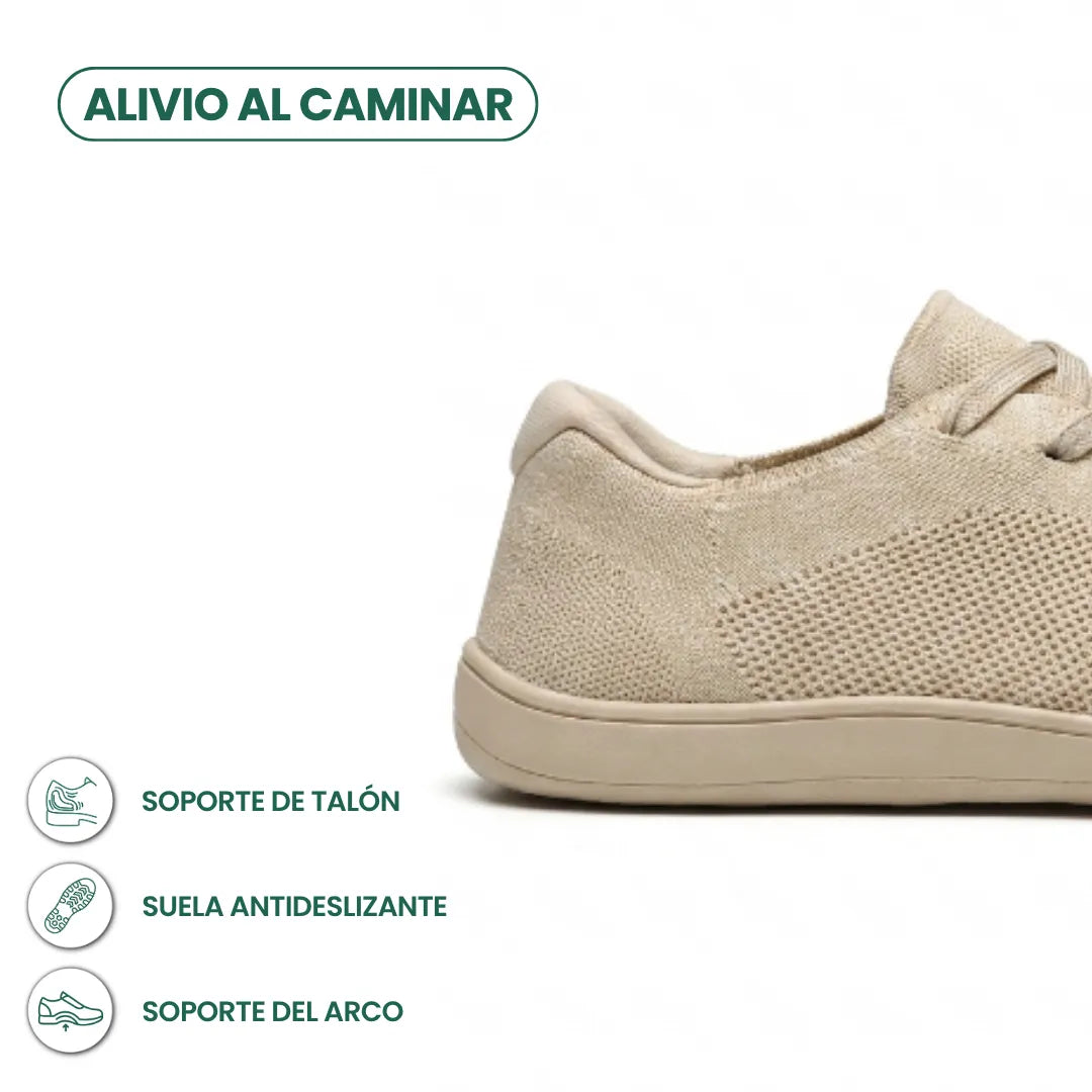 Close-up detail of the heel of a beige sneaker with callouts for heel support, non-slip sole and arch support.