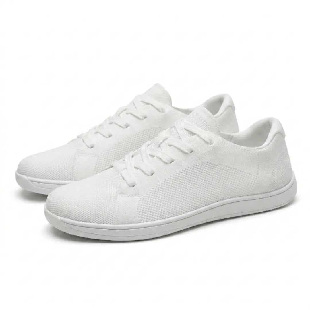 Pair of white lace-up mesh sneakers with thin flat white soles, shown at an angle from the front and side. 43