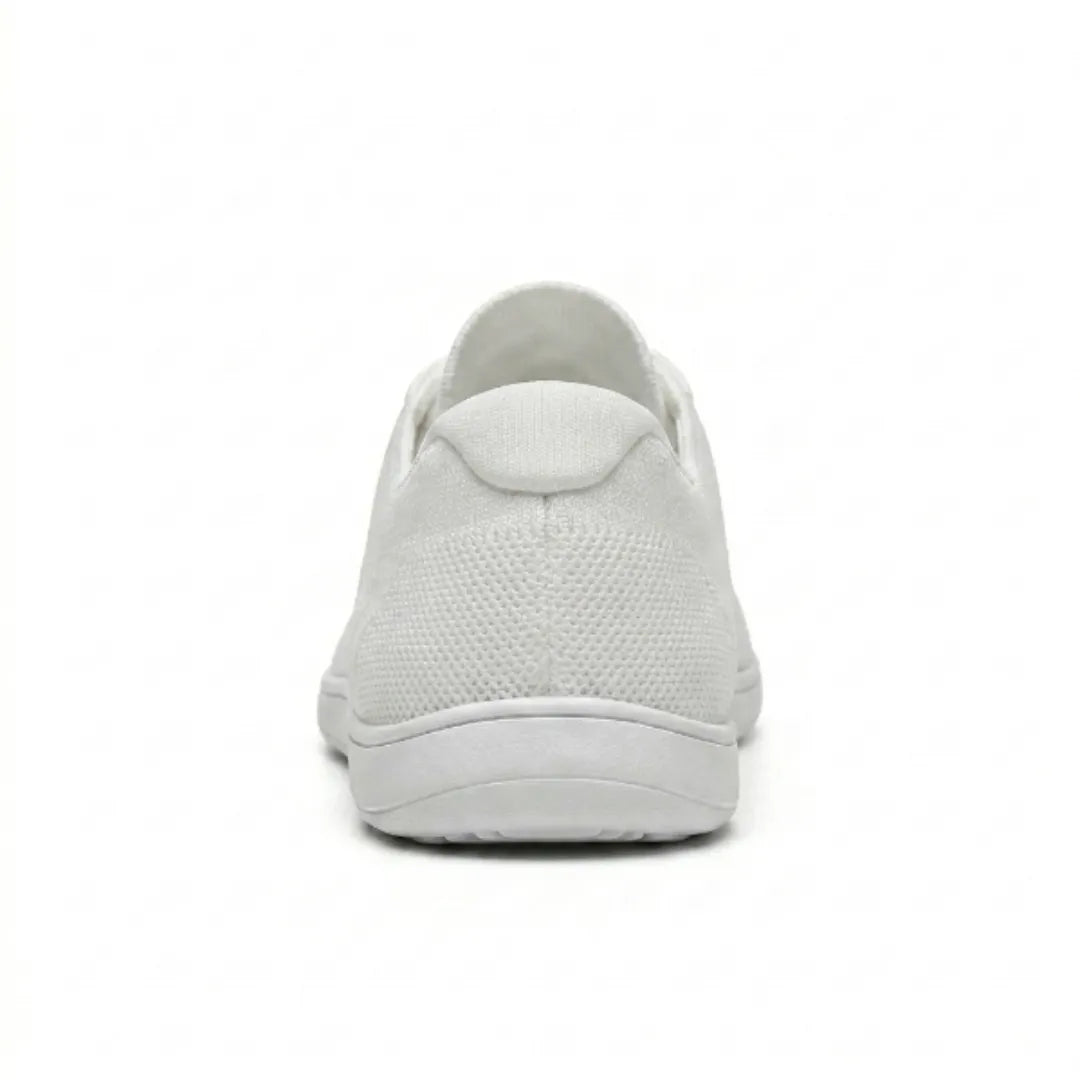 Back view of a white mesh sneaker showing the heel tab, textured knit upper and thin flat sole. 45