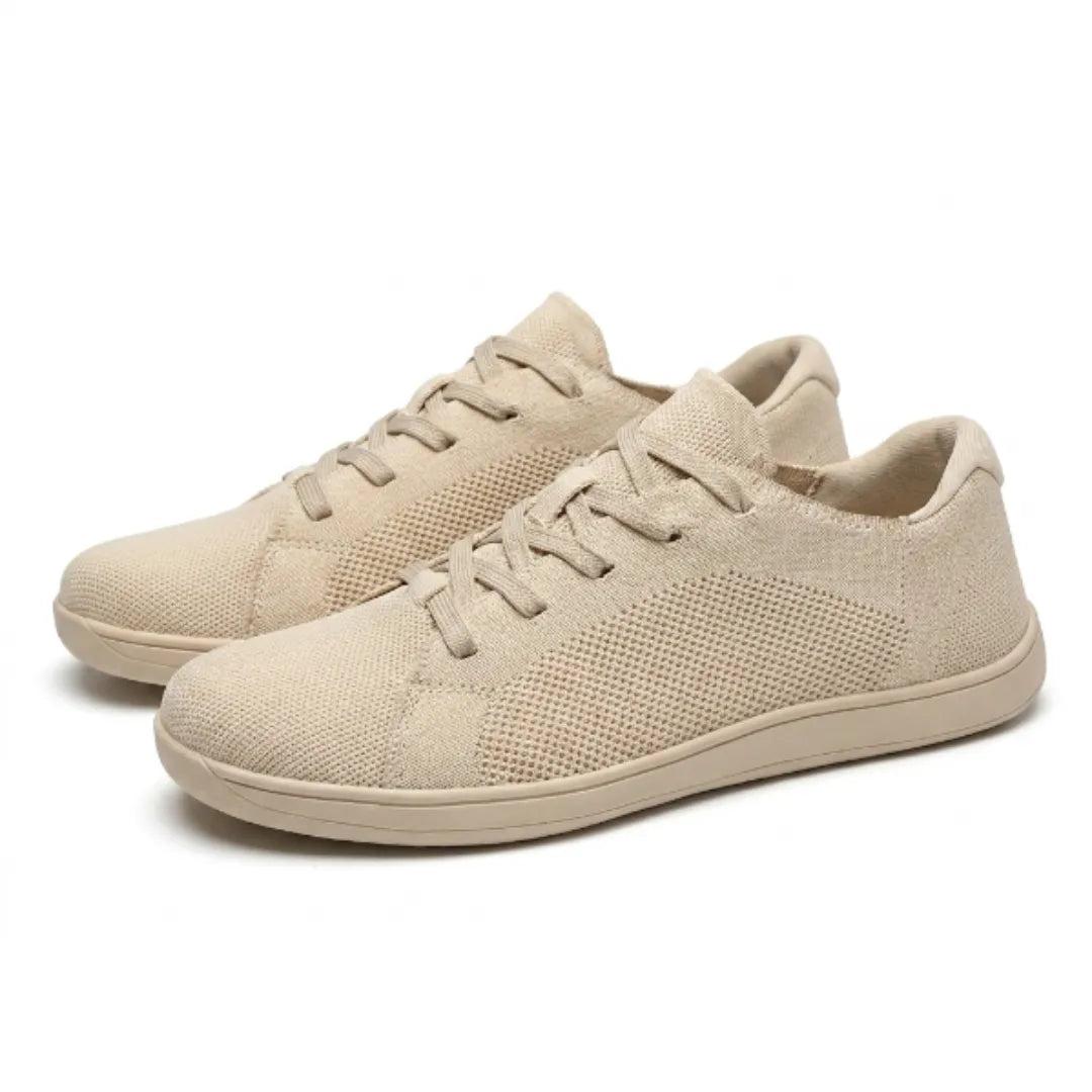 Pair of beige knit sneakers shown at an angle, one in front of the other, with matching beige laces and sole.