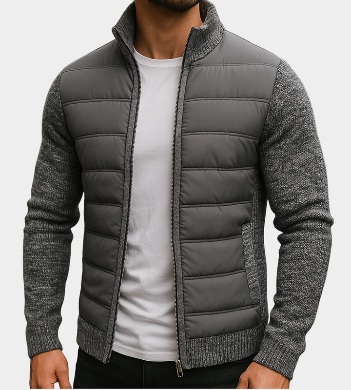 Man wearing the dark gray quilted jacket unzipped over a white tee, with marled knit sleeves, collar and ribbed hem. 1